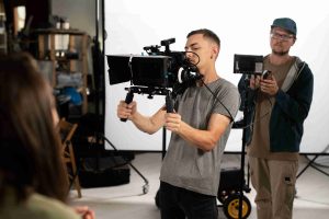 man filming with professional camera