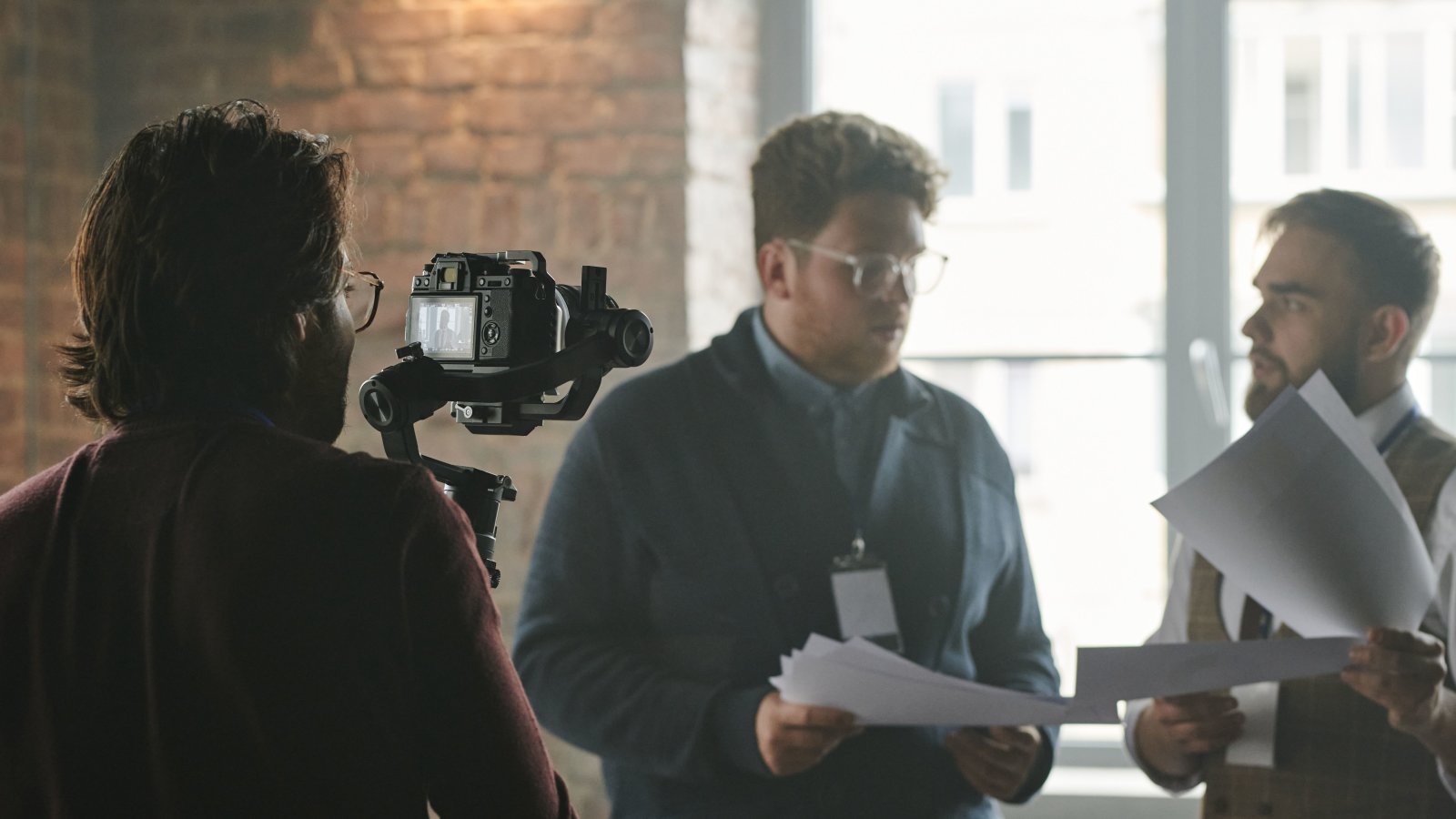 Professional team in modern office being filmed during a business discussion
